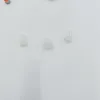 Three small, translucent white hearing aid domes are arranged on a white surface. Produktbild-Vorschau