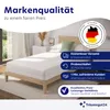 A bed with a mattress topper in a bedroom setting, with marketing text and icons. Produktbild-Vorschau