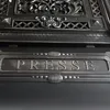A close-up view of a black mailbox with the word "PRESSE" embossed on it. Produktbild-Vorschau