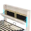 Close-up view of a beige upholstered bed frame headboard with integrated storage and LED lighting. Náhľad obrázku produktu