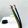 Close-up of three electrical wires with exposed copper ends, against a blurred background. Náhled obrázku produktu