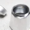 Close-up of the top of a moka pot on a speckled surface. Produktbild-Vorschau
