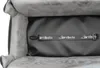 Close-up view of the interior of a pet car seat, showing a strap with a logo. Produktbild-Vorschau