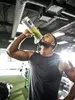 A man drinking a smoothie from a portable blender in a gym. Podgląd zdjęcia produktu