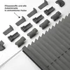 A collection of pleating accessories and a partially visible pleated blind are laid out on a white surface. Produktbild-Vorschau