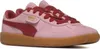 A pair of pink Puma sneakers with red accents and a gum sole, shown from a side-angle against a white background. Produktbild-Vorschau