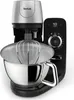 A close-up studio shot of a black and silver Tefal kitchen mixer with a whisk attachment in a stainless steel bowl. Produktbild-Vorschau