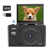 A black digital camera with a flip-up screen displaying a corgi puppy, along with accessories like an SD card and USB drive. Produktbild-Vorschau