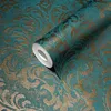 A roll of teal and gold damask patterned wallpaper. Produktbild-Vorschau