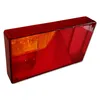 A close-up studio shot of a red and orange trailer tail light on a white background. Produktbild-Vorschau