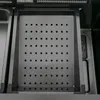 A close-up overhead view of a stainless steel sink with a perforated drainer insert. Náhled obrázku produktu