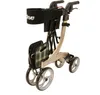 A gold rollator walker with a black basket and plaid seat is shown against a white background. Produktbild-Vorschau