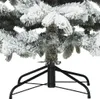Close-up view of the base and lower branches of a flocked artificial Christmas tree. Náhled obrázku produktu