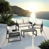 An outdoor lounge set is placed on a patio next to an infinity pool with a scenic ocean view at sunset. Voir les images du produit