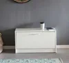 A white shoe cabinet is placed against a gray wall, with a cup and a book on top. Náhled obrázku produktu