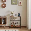 A shoe rack with shoes and decorative items in a room. Produktbild-Vorschau