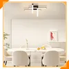 A modern dining room with a marble-topped table and chairs, illuminated by a contemporary ceiling light. Voir les images du produit