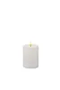 A white LED candle with a lit flame. Produktbild-Vorschau