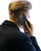 A person is holding a smartphone with a black case to their ear, as if on a call. Produktbild-Vorschau