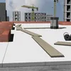 Construction site with building materials and unfinished buildings in the background. Náhľad obrázku produktu
