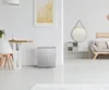 A mini-refrigerator is shown in a bright, modern living space, next to a dining table. Produktbild-Vorschau