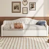 A tufted daybed with a throw blanket and pillow is shown in a room with framed pictures on the wall and a patterned rug on the floor. Náhled obrázku produktu