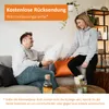 A couple relaxing on a couch, interacting with a pillow. Voir les images du produit