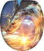 A dynamic image of a wave crashing with a sunset in the background, framed in an oval shape. Náhled obrázku produktu