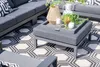 An outdoor living space with a modular sofa and ottoman on a patterned rug. Produktbild-Vorschau