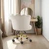 A cream-colored velvet office chair with a gold base is shown in a room with a vanity and curtains. Produktbild-Vorschau