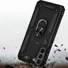 A black phone case with a ring holder is shown in a dynamic, falling pose against a rocky, dusty background. Produktbild-Vorschau