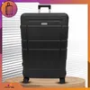 A black suitcase is displayed on a wooden surface with a patterned background. Anteprima dell’immagine prodotto