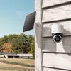 A white eufy S330 4G LTE security camera with a solar panel attached to the side of a wooden house, overlooking a rural landscape with trees and farm buildings. Náhľad obrázku produktu