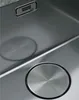 A close-up view of a stainless steel sink with a drain cover and a brand logo. Produktbild-Vorschau