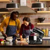 A couple is baking in a kitchen with a stand mixer. Produktbild-Vorschau