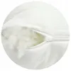 A close-up view of a white pillow with a zipper partially open, revealing the filling. Produktbild-Vorschau