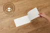 Selbstklebende Designplanken in Eicheoptik Natur, ausgelegt auf weißem Untergrund.  Produktbild-Vorschau