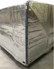 A close-up view of a silver pallet cover with a zipper, resting on a wooden pallet. Produktbild-Vorschau