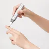 A hand holding a TIRTIR Collagen Lifting Eye Cream applicator pen, with the applicator tip touching a finger. Podgląd zdjęcia produktu