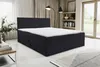 A bedroom scene with a bed, rug, and lamp. Voir les images du produit