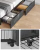 A bed frame with storage drawers, showing close-ups of the wheels and drawer construction. Náhled obrázku produktu