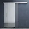 A modern glass sliding door with a silver handle, mounted on a dark gray wall. Produktbild-Vorschau