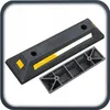 A black parking curb with yellow reflective strips and a black plastic insert, shown on a white background. Produktbild-Vorschau