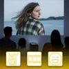 A family is watching a movie projected by a mini projector. Voir les images du produit