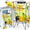 A beverage dispenser with a tap and stand, shown next to its packaging, with fruit illustrations. Produktbild-Vorschau