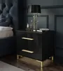 A bedside table with two drawers next to a bed in a dark, moody bedroom. Produktbild-Vorschau