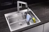 A stainless steel kitchen sink with a faucet, sponge, and dish towel. Náhled obrázku produktu