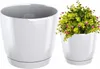 A white plant pot with a saucer, and a separate image of a similar pot with a plant. Voir les images du produit