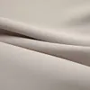 A close-up view of beige fabric, showing its texture and folds. Náhled obrázku produktu