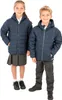 Two children, a boy and a girl, are posing for a product image, both wearing navy blue padded jackets. Produktbild-Vorschau